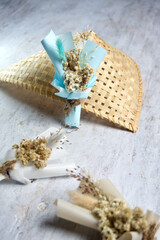 Close Up Mini Bouquet with Blue Cellophane Paper Wrapping Lays on Natural Bamboo Basket