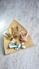 A Group of Colourful Pastel Mini Bouquet with Cellophane Paper Wrapping Lays on Natural Bamboo Basket