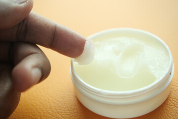Close up of man hand using petroleum jelly