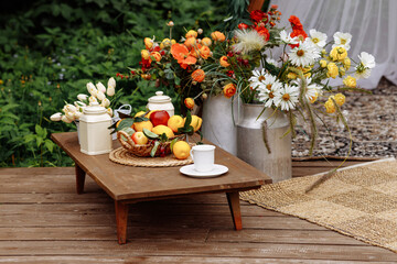 Wedding wooden arch in boho style, decorated with wildflowers. Rustic hippie wedding ceremony. Fresh flowers create a contemporary design and the perfect backdrop for decorating your ceremony.