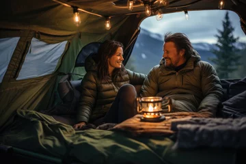 Schilderijen op glas Couple camping in tent at night. They are looking at each other and smiling. created by generative AI technology. © hakule