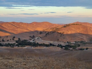 The mountain tops turn a golden hue in the light of the setting sun in Hidden Valley Open Space