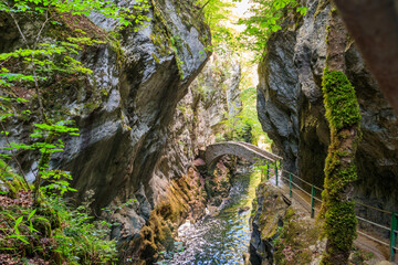 Old small stone bridge over river at Gorges de l'Areuse, Switzerland