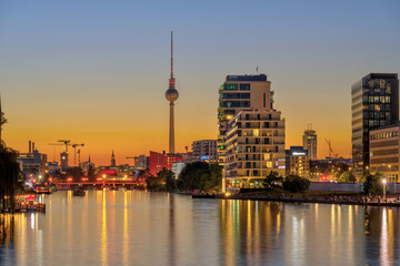 Fototapeta na wymiar The river Spree in Berlin after sunset with the famous TV Tower in the back