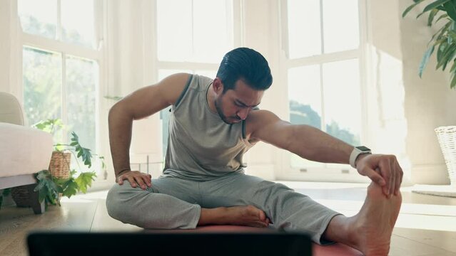 Man, stretching and touch foot for yoga at home, virtual exercise class with laptop and fitness in living room. Flexibility, body and wellness with pilates, online lesson for health and self care