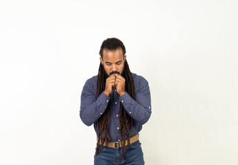 Portrait of a frightened adult latin man dressed in plaid shirt holding hands at his mouth and...