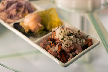 menu and fresh dishes from a restaurant with Chilean sea food ready to be served and enjoyed. seafood soup, Chilean salad