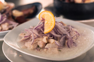 menu and fresh dishes from a restaurant with Chilean food ready to be served and enjoyed. seafood soup with salad