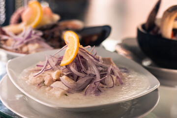 menu and fresh dishes from a restaurant with Chilean food ready to be served and enjoyed. seafood soup with salad