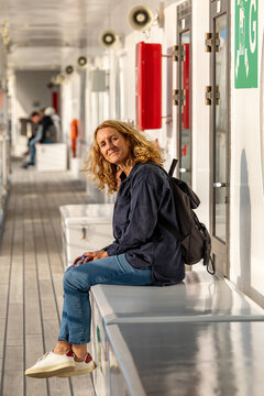 Stockholm, Sweden  A woman passenger  on the deck in the sun on the Silja Line ferrry to Helsinki, Finland.