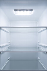 refrigerator interior with light in the upper area