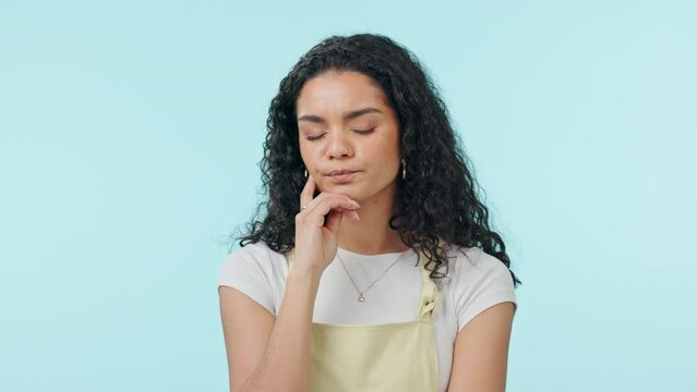 Confused, woman and thinking of doubt in studio for planning, question why and brainstorming ideas on blue background. Curious model wonder about decision, remember memory or problem solving solution