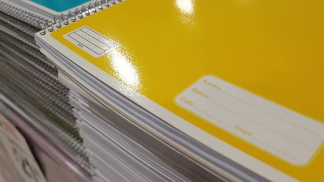 Notebooks with colored covers for students on a shelf