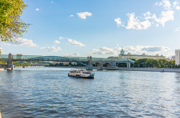 View of the Moscow river embakment, Pushkinsky bridge and cruise ships at sunset.