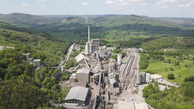 Aerial drone flight over Breedon Hope Cement Works with a view of the surrounding Peak District.