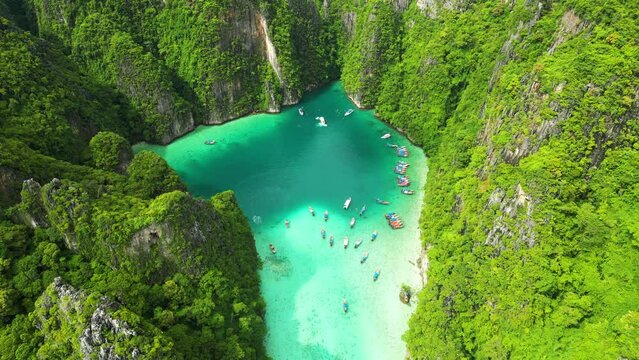 Epic Phi Phi island lagoon in middle of tropical green mountains. Aerial