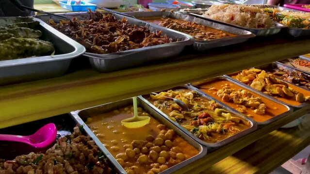 Indonesian street food Warteg or "Warung Tegal". Various kinds of food served on stainless steel trays. A place to eat for ordinary people. Folk food. Cheap food - Indonesian dish
