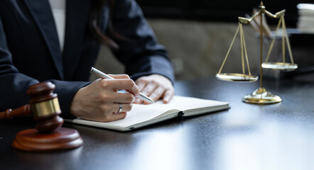 Close up lawyer businesswoman working on lawbook in office workplace for consultant lawyer concept.