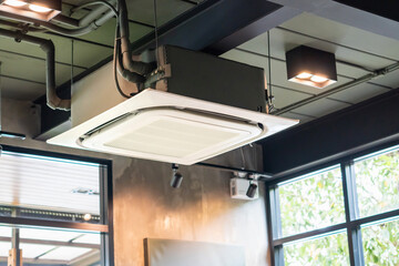 Modern ceiling mounted cassette type air conditioning system in coffee shop