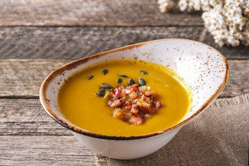 Autumn pumpkin soup with bacon and pumpkin seed