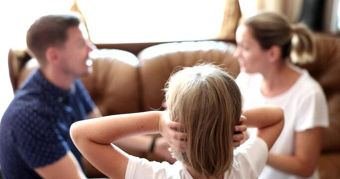 Frustrated little girl feels depressed. Angry parents quarreling at home