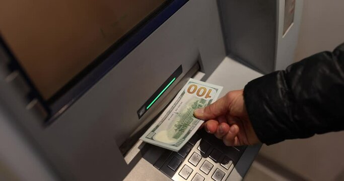 Withdrawing cash from ATM and receiving money in dollars from ATM. Banking services