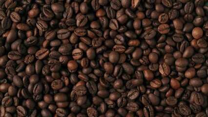 Closeup shot of aromatic roasted coffee beans background. Advertising area, template.