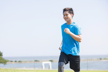 シーサイドでジョギングする若いアジア人