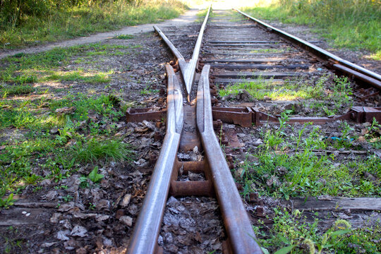 Railway tracks in the countryside. Selective focus on rails.