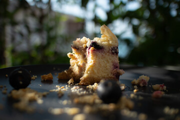 Blueberry cheese cake on dark plate in the cafe.