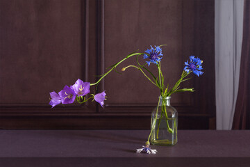 Floral arrangement in a minimalist style on a dark background.
