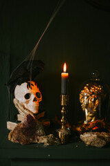 Halloween party decor in gloomy dark colors with retro elements and skulls