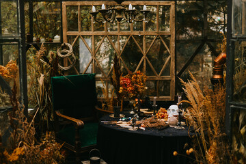 Halloween party decor in gloomy dark colors with the table is set