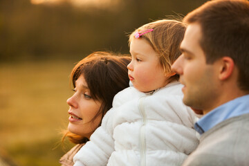 Fototapeta premium 'Look, daughter, the valley's beauty won't be yours' Loving parents and child share an autumnal moment, basking in nature's hues and dreaming of what lies ahead