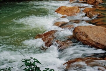 The waterfall and stones in tropical forest natural at Khao Banchop Waterfall in Chanthaburi...