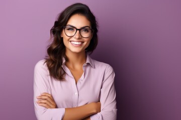 Portrait of happy smiling young businesswoman in glasses, over violet background