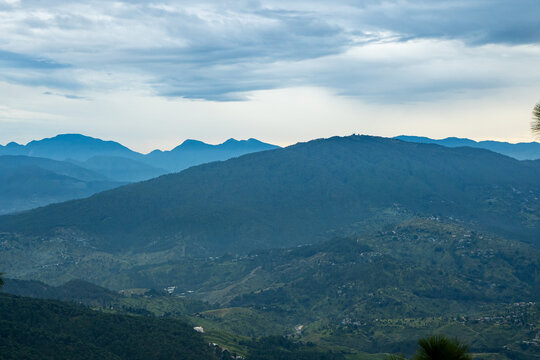 Beautiful landscape view of Foggy pine forest and sunset at himalayan range, Almora, Ranikhet, Uttarakhand, India