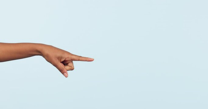 Hand, pointing and choice with a person closeup on space on a studio blue background for marketing. Finger, vote or decision with an adult selection of a candidate during recruitment on mockup