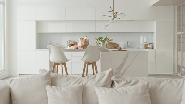Interior of modern kitchen-living room combo with stylish minimalist design in white colors, no people there