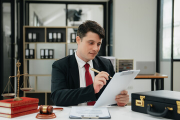 Man lawyer working and gavel, tablet, laptop in front, Advice justice and law concept.