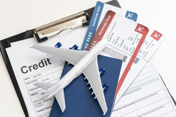 Two boarding passes with a white model airplane on a laptop keyboard. An idea about aviation or...