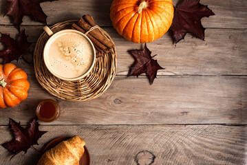 Autumn background with coffee and pumpkins