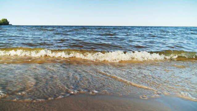 Beautiful waves roll over the river beach. Close up shot