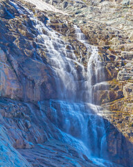 closeup high waterfall rushing from mount slope