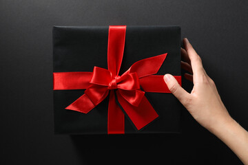 The concept of black friday, a gift in a black wrapper.