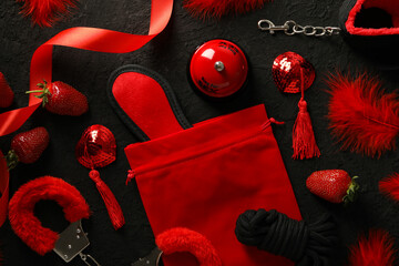 A collection of sex toys on a dark background.