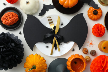 Table setting for Halloween, spooky decorations with pumpkins and bats