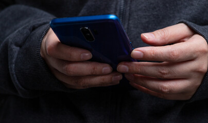 A smartphone in the hands of a girl