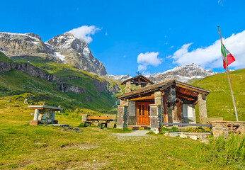 Breuil-Cervinia (Italy) - A view of Cervinia mountain town with Cervino mount peak of Alps, trekking paths and Lago Blu touristic lake. In Valle d'Aosta region, north Italy.