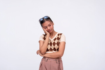 A young asian woman tries to remain calm and endures a throbbing toothache. Isolated on a white...